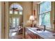 Elegant wet bar with tile backsplash, wood cabinetry, undermount sink, and natural light from the window at 2504 White Thorne Ln, Waxhaw, NC 28173