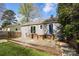 Charming home exterior with a spacious deck and landscaped backyard, perfect for outdoor gatherings and relaxation at 2741 Cowles Rd, Charlotte, NC 28208