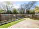 Private backyard with lush greenery and a wooden deck, creating an inviting outdoor space for relaxation and entertainment at 2741 Cowles Rd, Charlotte, NC 28208