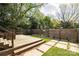 Secluded backyard features a deck, patio, and lush greenery, creating a serene outdoor oasis for entertaining and relaxation at 2741 Cowles Rd, Charlotte, NC 28208