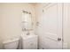 Well-lit bathroom featuring a modern vanity, toilet, and a mirror reflecting the shower, providing a functional space at 2741 Cowles Rd, Charlotte, NC 28208