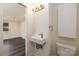 Contemporary half-bathroom with sleek fixtures and modern design, providing convenience and style for guests at 2741 Cowles Rd, Charlotte, NC 28208