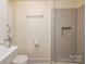 A renovated bathroom offers a modern vanity and beautifully tiled walk-in shower at 2741 Cowles Rd, Charlotte, NC 28208