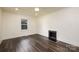 A bright bedroom with vinyl flooring, trim detail, and a stylish fireplace feature at 2741 Cowles Rd, Charlotte, NC 28208