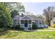 Charming single-story home featuring a cozy front porch, well-maintained lawn, and mature trees at 2741 Cowles Rd, Charlotte, NC 28208