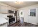 Updated kitchen features stainless steel appliances, gray cabinetry, and a convenient layout at 2741 Cowles Rd, Charlotte, NC 28208