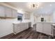 Bright kitchen with stainless steel appliances, gray cabinets, and modern lighting fixtures at 2741 Cowles Rd, Charlotte, NC 28208