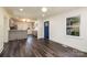 An open floor plan boasts stylish flooring and leads into a kitchen with a peninsula and stainless appliances at 2741 Cowles Rd, Charlotte, NC 28208