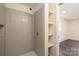 Modern shower with grey tiling, stylish fixtures, and a built-in niche for storage, enhancing the bathroom's appeal at 2741 Cowles Rd, Charlotte, NC 28208