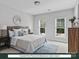 Stylishly furnished bedroom with two windows, bedside table, and patterned area rug at 280 Gilead Rd, Huntersville, NC 28078