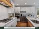 Modern kitchen with white cabinets, stainless steel appliances, and a gas cooktop at 280 Gilead Rd, Huntersville, NC 28078