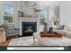 Cozy living room with a gas log fireplace, large windows, and neutral decor at 280 Gilead Rd, Huntersville, NC 28078