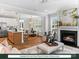 Open living space with a modern kitchen, dining area, and cozy living room with fireplace and natural light at 280 Gilead Rd, Huntersville, NC 28078