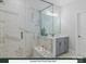 Main bath with walk-in shower, marble tile, and a vanity with mirror at 280 Gilead Rd, Huntersville, NC 28078