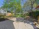 Beautiful backyard with a brick patio, outdoor seating, and mature trees at 3005 Somerset Dr, Charlotte, NC 28209