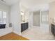 Bathroom featuring marble floors, a soaking tub, and a glass shower at 3005 Somerset Dr, Charlotte, NC 28209