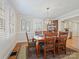 Bright dining room featuring wood floors, shuttered windows, and stylish light fixture at 3005 Somerset Dr, Charlotte, NC 28209
