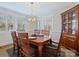 Elegant dining room with a wooden table set for six and ample natural light at 3005 Somerset Dr, Charlotte, NC 28209