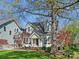 Charming home with a manicured lawn, mature trees, and inviting front porch at 3005 Somerset Dr, Charlotte, NC 28209