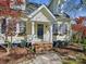 Inviting front entrance with detailed trim work, a cozy porch, and landscaped garden beds at 3005 Somerset Dr, Charlotte, NC 28209