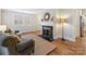 Bright living room with large windows, hardwood floors, and a charming fireplace at 3005 Somerset Dr, Charlotte, NC 28209
