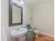 Charming powder room with pedestal sink, wainscotting, and stylish decor at 3005 Somerset Dr, Charlotte, NC 28209