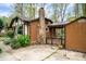 Home's backyard showing brick chimney and covered deck with access to the backyard at 313 E Church St, Stanley, NC 28164