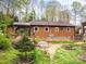 Exterior view of backyard featuring a deck, patio and small garden at 313 E Church St, Stanley, NC 28164