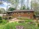 View of the backyard with a deck and garden area at 313 E Church St, Stanley, NC 28164