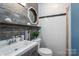 Stylish half bathroom with rustic wood accent wall and white subway tile at 313 E Church St, Stanley, NC 28164