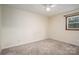 Neutral carpeted bedroom featuring a large window and a ceiling fan at 313 E Church St, Stanley, NC 28164