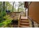 Elevated wooden deck with staircase and wood railings at 313 E Church St, Stanley, NC 28164