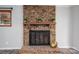 Brick fireplace with decorative mantle is adorned with plants and a bronze bowl at 313 E Church St, Stanley, NC 28164