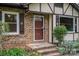 Close-up of a charming front door with brick steps and decorative shutters at 313 E Church St, Stanley, NC 28164