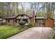 Charming brick home with a well-manicured lawn, covered car-port, and brick chimney at 313 E Church St, Stanley, NC 28164