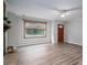 Bright living room features wood-look floors, large windows, and a ceiling fan at 313 E Church St, Stanley, NC 28164