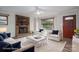 Cozy living room with a brick fireplace, plush seating, and natural light at 313 E Church St, Stanley, NC 28164