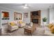 The staged living room includes a brick fireplace, neutral furniture, and a decorative rug at 313 E Church St, Stanley, NC 28164