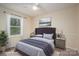 Staged main bedroom with a large window, elegant decor, and a comfortable queen bed at 313 E Church St, Stanley, NC 28164