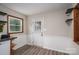 Mud room features wood-look flooring, white wainscoting, and a glass-paneled door for natural light at 313 E Church St, Stanley, NC 28164