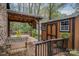View of a shed, and covered portion of the wooden deck, with railing at 313 E Church St, Stanley, NC 28164