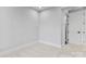 Minimalist bedroom design with neutral tones, plush carpeting, and a white door, creating a serene atmosphere at 3433 Byrnes St, Charlotte, NC 28205