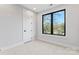 Bright bedroom features a modern window, plush carpet, and neutral paint, creating a calming and inviting space at 3433 Byrnes St, Charlotte, NC 28205