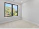 Bedroom with plush carpet flooring, neutral paint, and a large window at 3433 Byrnes St, Charlotte, NC 28205