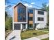 Modern home featuring mixed siding, a driveway, and manicured front yard at 3433 Byrnes St, Charlotte, NC 28205