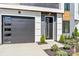 Contemporary home featuring a black garage door, stylish front door with modern landscaping at 3433 Byrnes St, Charlotte, NC 28205
