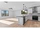 Open concept kitchen with modern lighting, stainless steel appliances, and black countertops at 3433 Byrnes St, Charlotte, NC 28205
