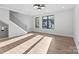 Bright open living room with contemporary staircase, modern lighting, and natural light at 3433 Byrnes St, Charlotte, NC 28205
