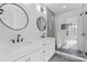 Modern bathroom featuring dual sinks, matte black fixtures, and a large glass-enclosed shower with tile surround at 3437 Byrnes St, Charlotte, NC 28205