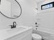 Modern bathroom featuring a bathtub, sleek fixtures, and a round mirror at 3437 Byrnes St, Charlotte, NC 28205